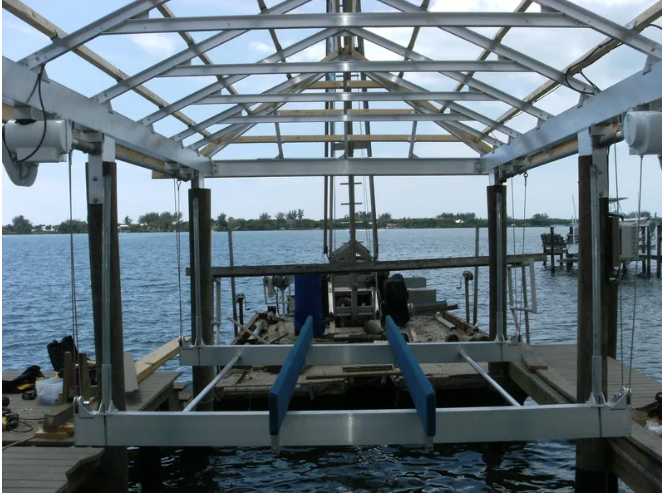 Boathouse lift under an aluminum roof frame