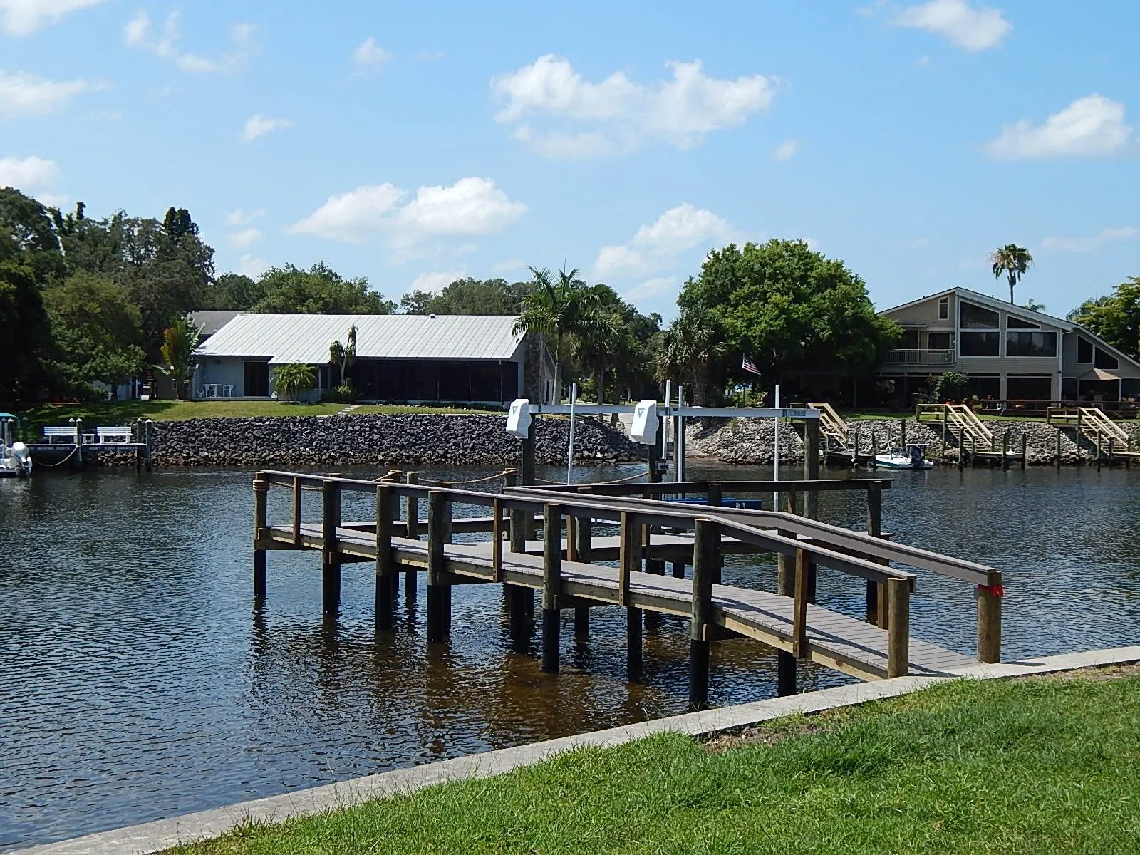 Dock with handrails and a gangway, boat lift beyond