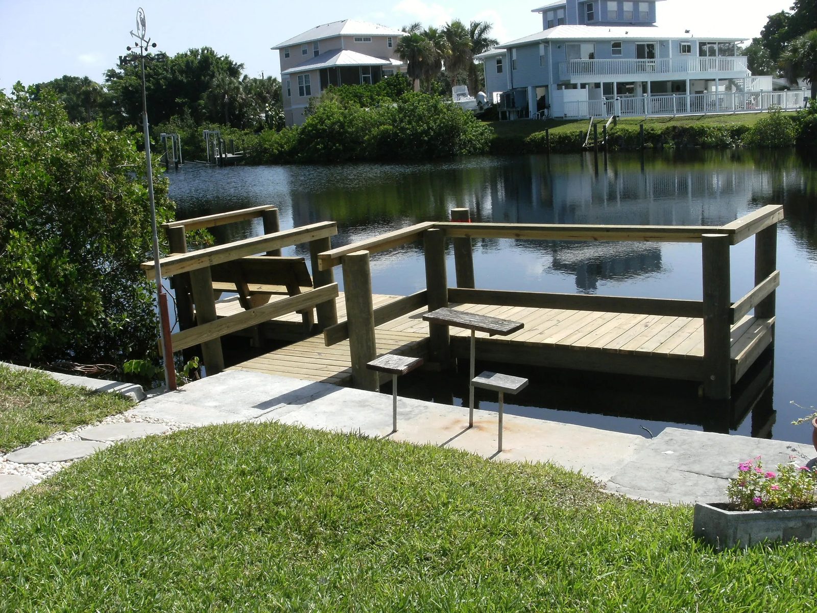 Dock with railing, bench seating and a fish cleaning table