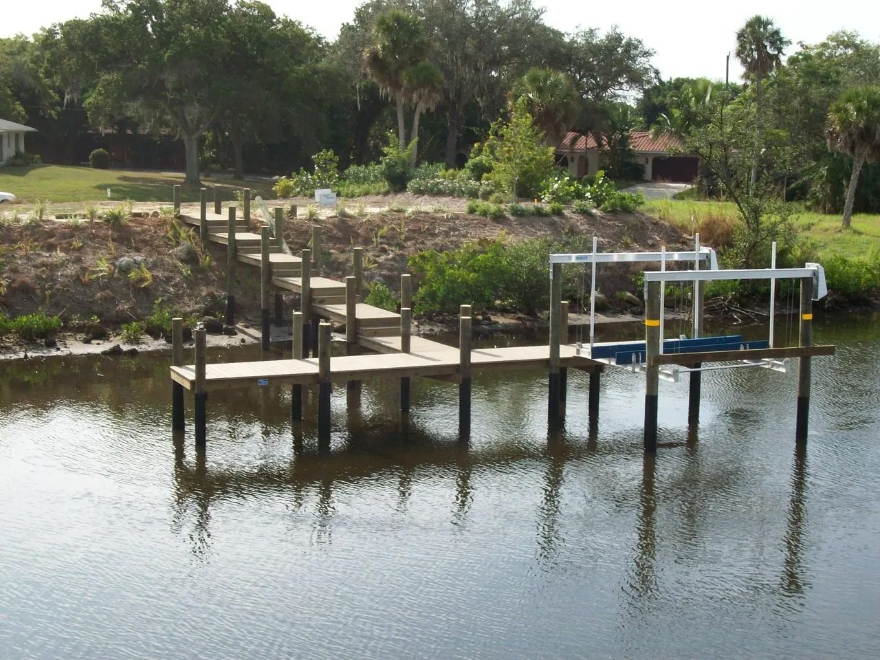 Dock with shoreline steps leading down the bank to a boat lift
