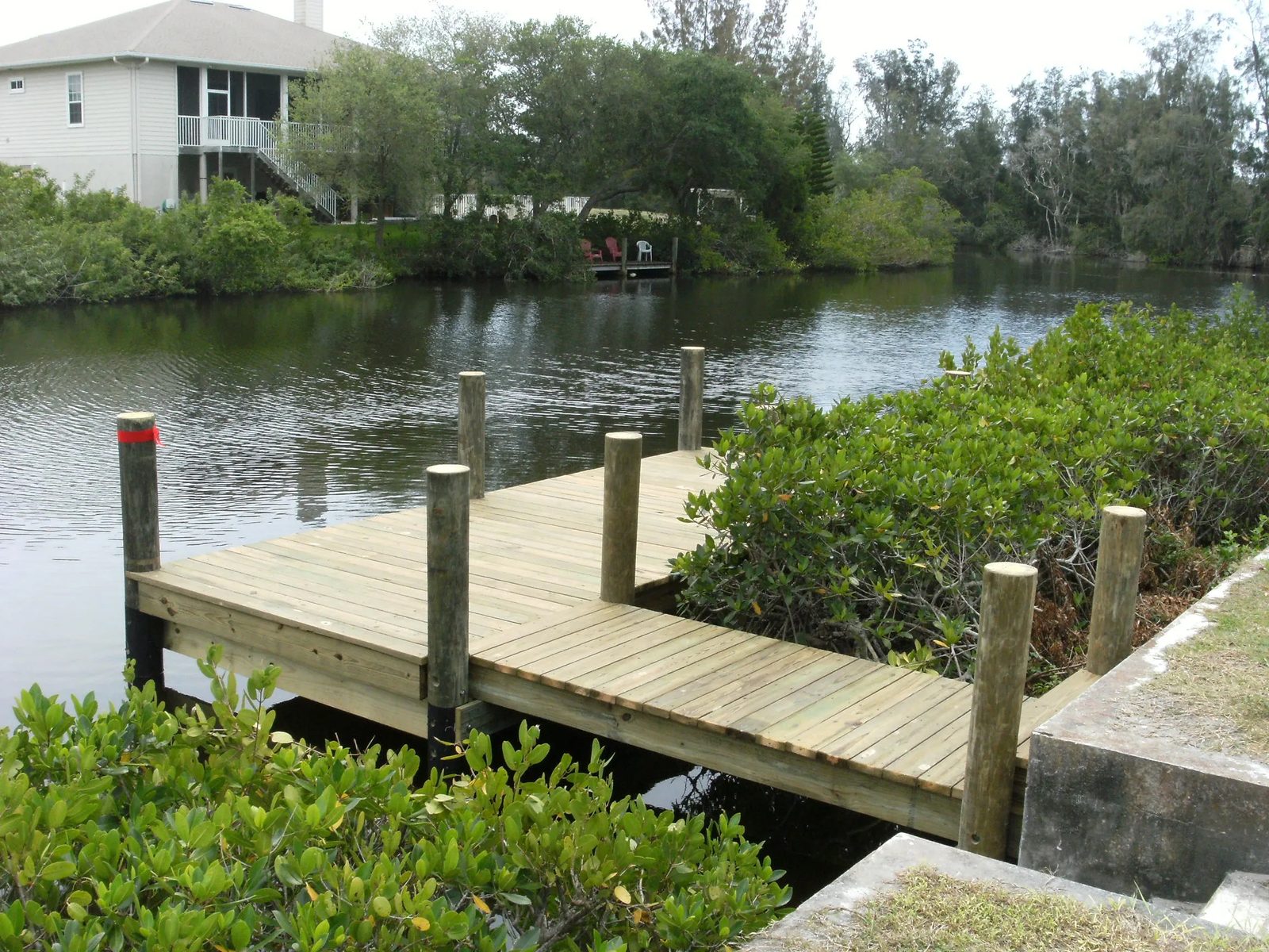 Timber dock running out through mangroves to open water