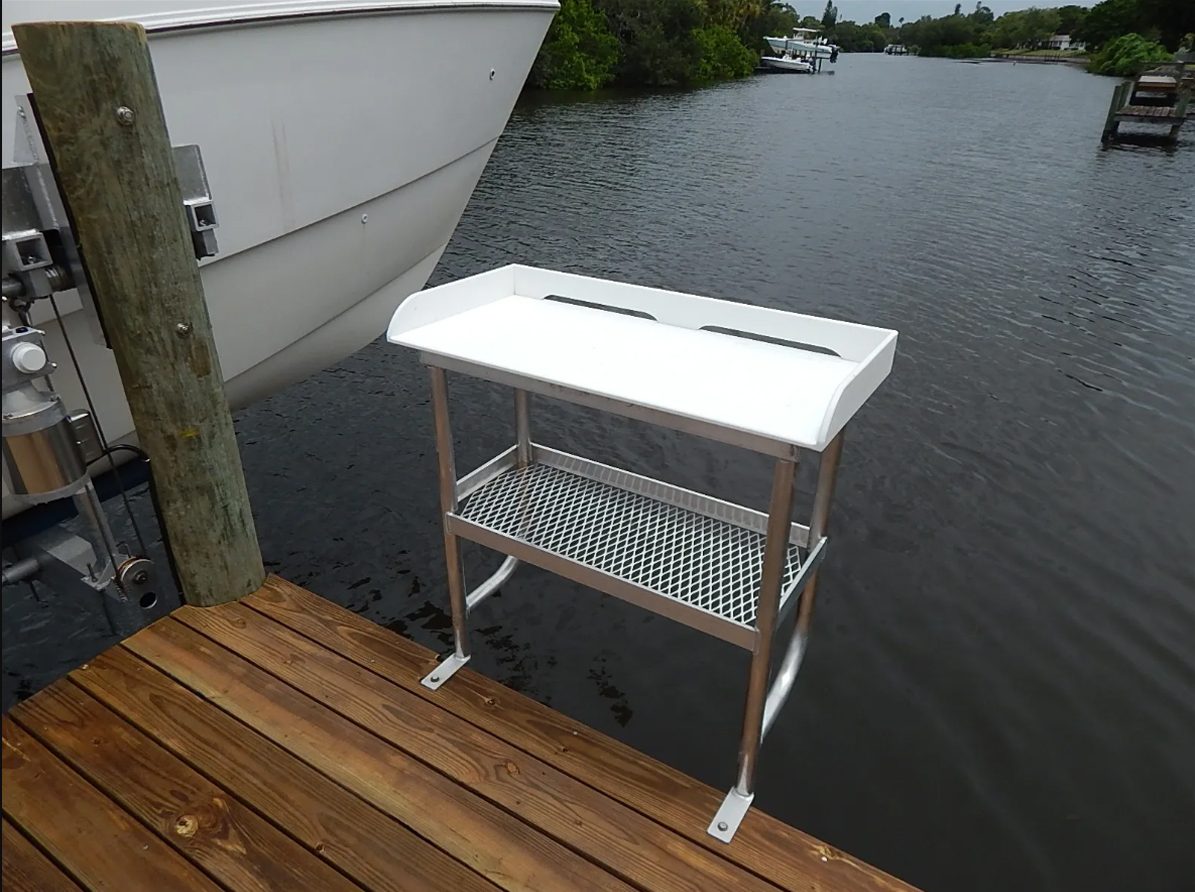 Cantilevered fish cleaning table on the side of a dock