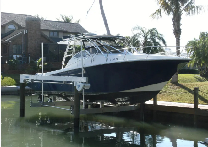 Four post boat lift with a sport boat raised on a residential canal