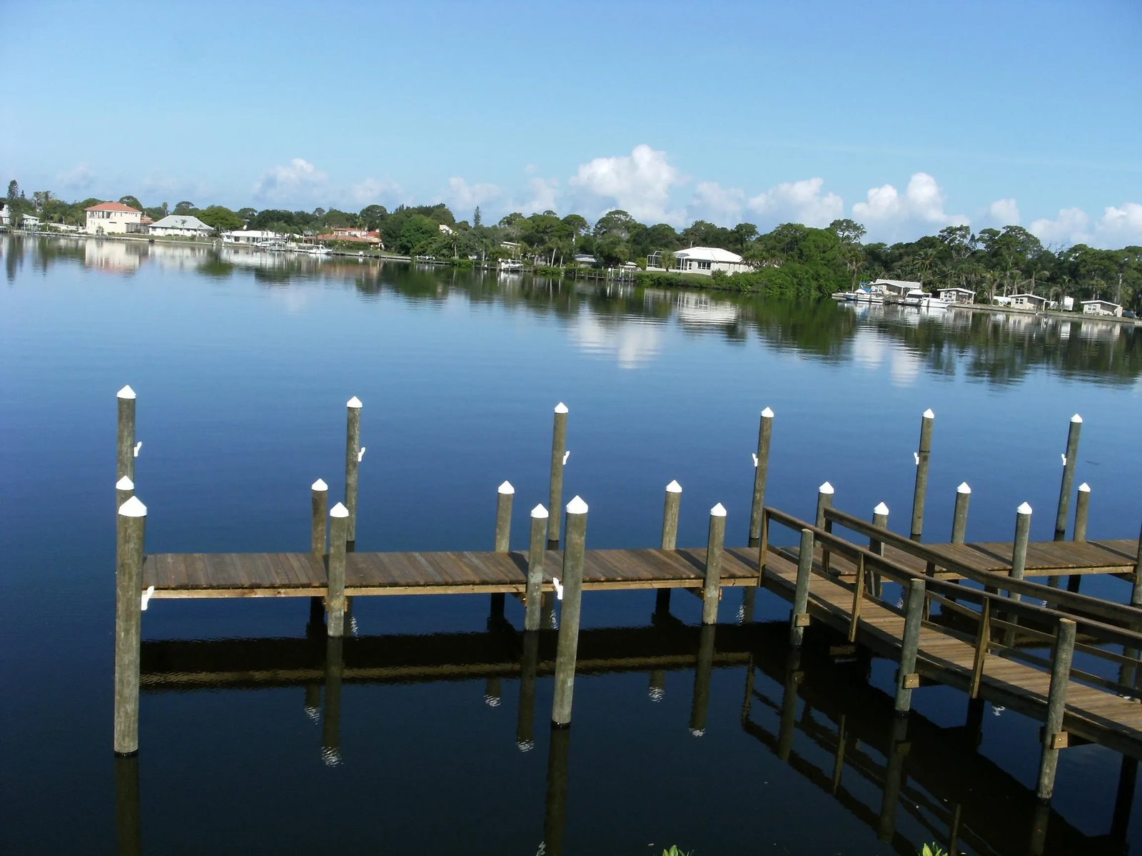 Long dock with white pile caps on open water