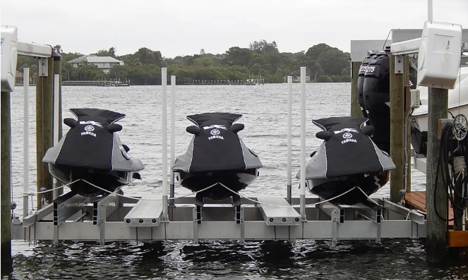 Three personal watercraft raised on a multi PWC lift