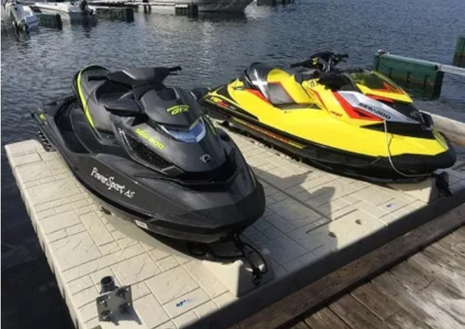 Two personal watercraft on a floating dock platform